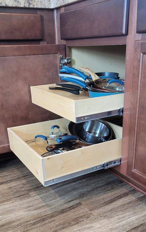Kitchen cabinets features a warm wood finish! Sliding shelves in all of the base cabinets for efficiently storing pots, pans, and lids.
