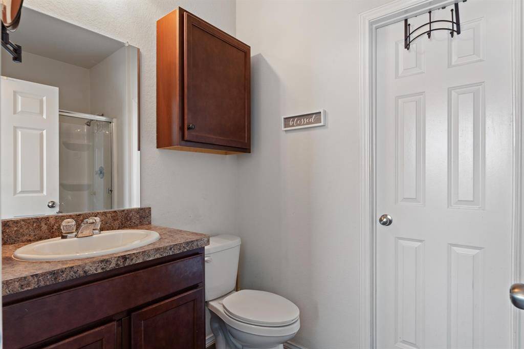 Primary bathroom with dark colored vanity.