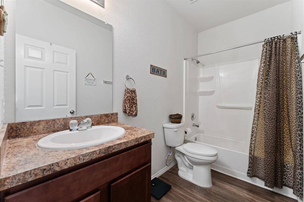 Secondary or guest bathroom features a sleek design with a white bathtub-shower combo.