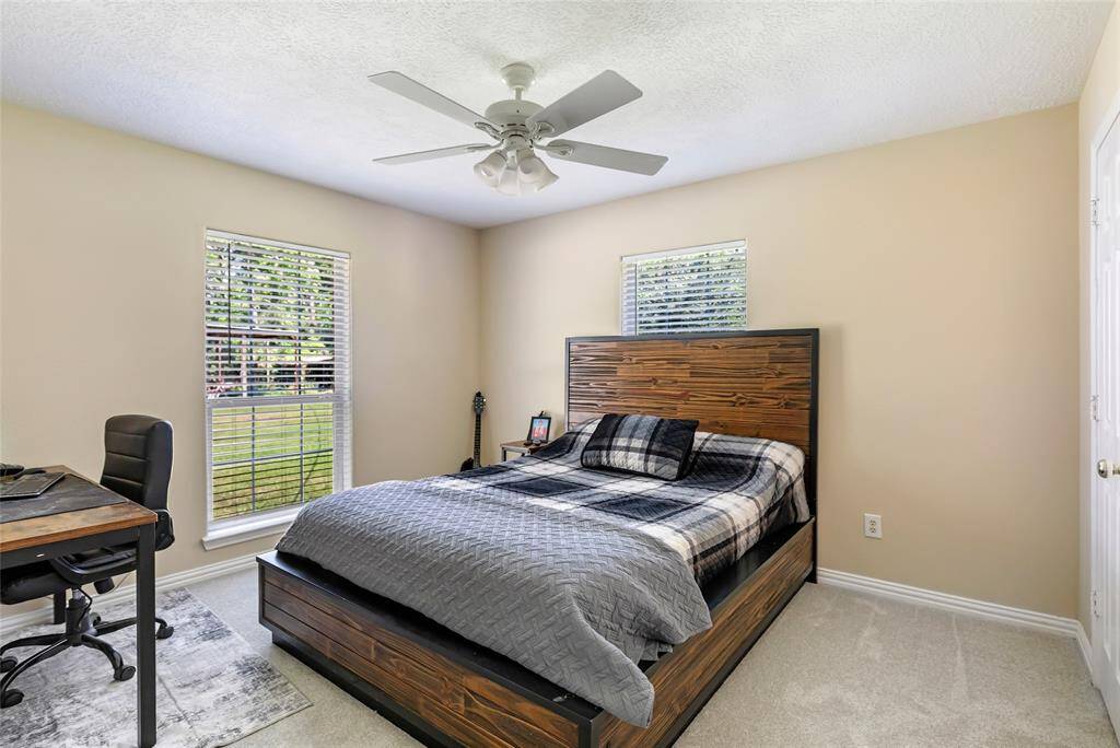 With ample space and large windows that bring the outdoors in, this secondary bedroom is the perfect blend of comfort and light. Whether used as a bedroom, playroom, or study, it offers versatility and style.