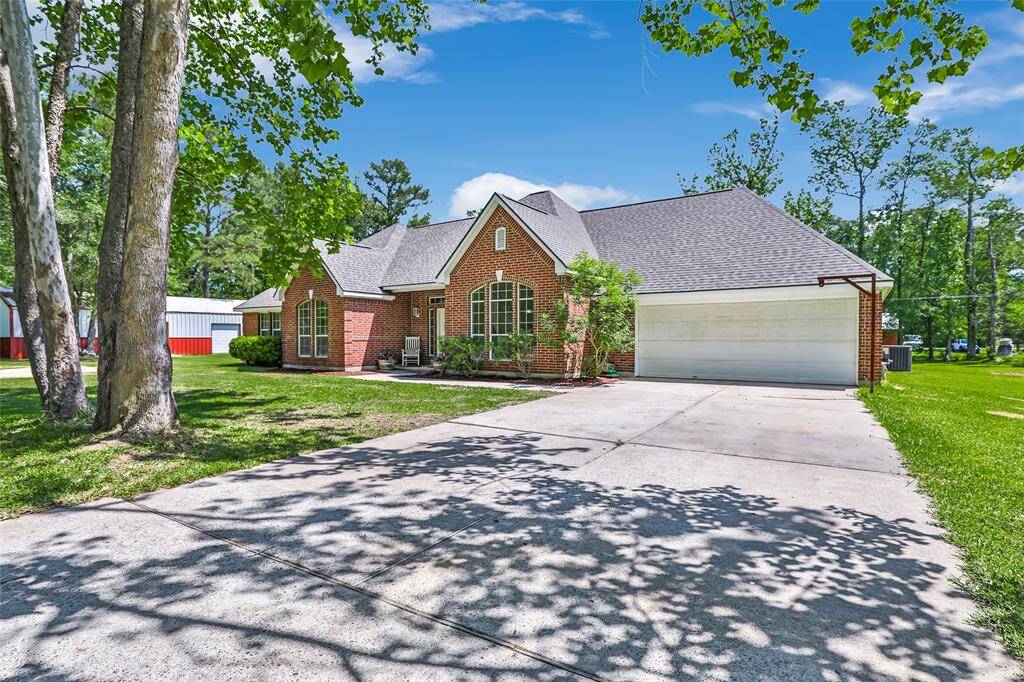 Ample parking with a wide driveway and attached garage — convenience and function, right at your fingertips.