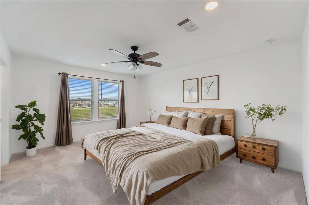 This master bedroom has everything you need to make it your retreat! There's a beautiful ensuite bathroom, and natural light keeps the room bright and inviting. If you're searching for the perfect place to unwind, you've found it!