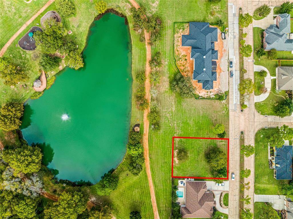 Aerial view of the lot and beautiful pond.