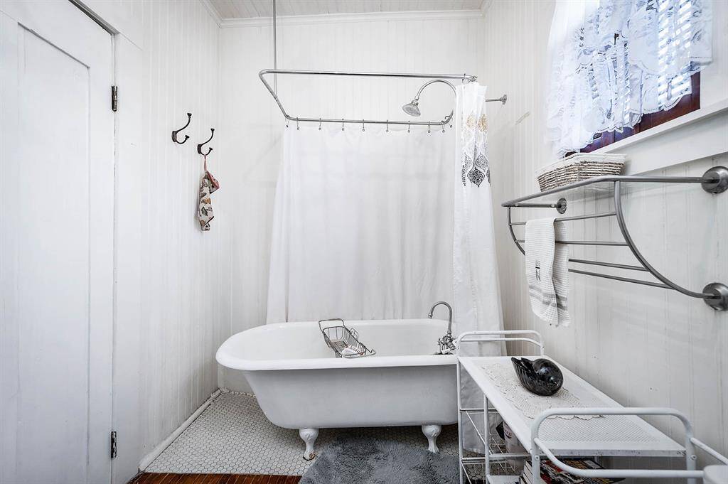Primary Bathroom has a clawfoot bathub with shower.