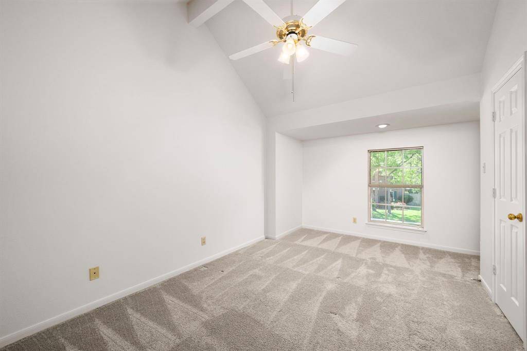 This secondary bedroom #3 overlooks the front of the house and has a small built-in desk in the far right-hand corner.