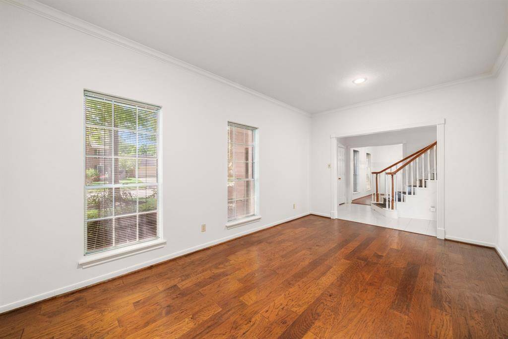 Another view of the bright living space with hardwood floors & large windows.  Perfect for a warm and inviting home atmosphere.