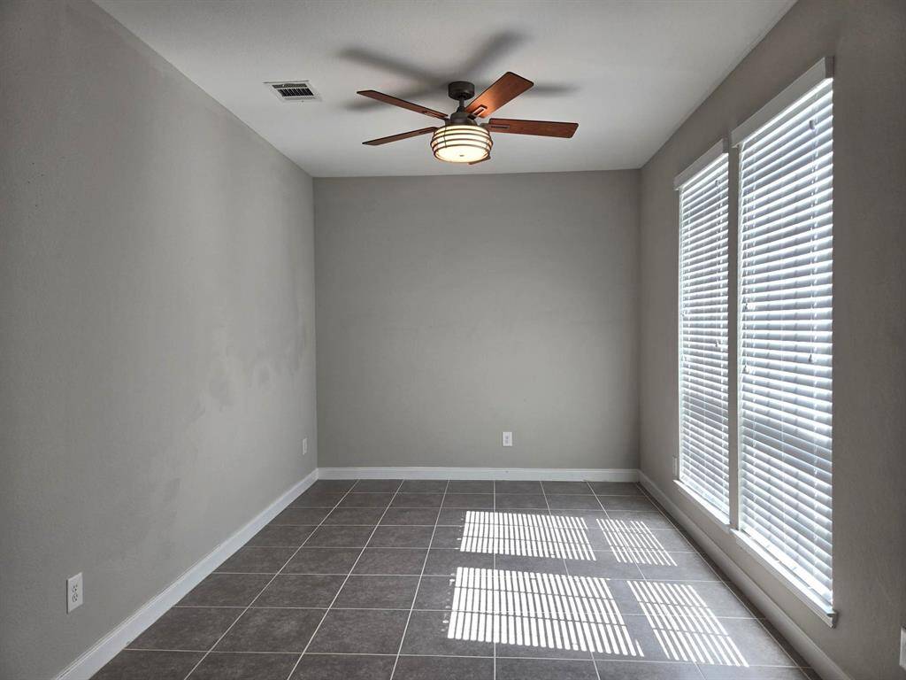 Great size formal living room, office, formal dining room or flex room with large window and ceiling fan.It's located to the right after you enter.