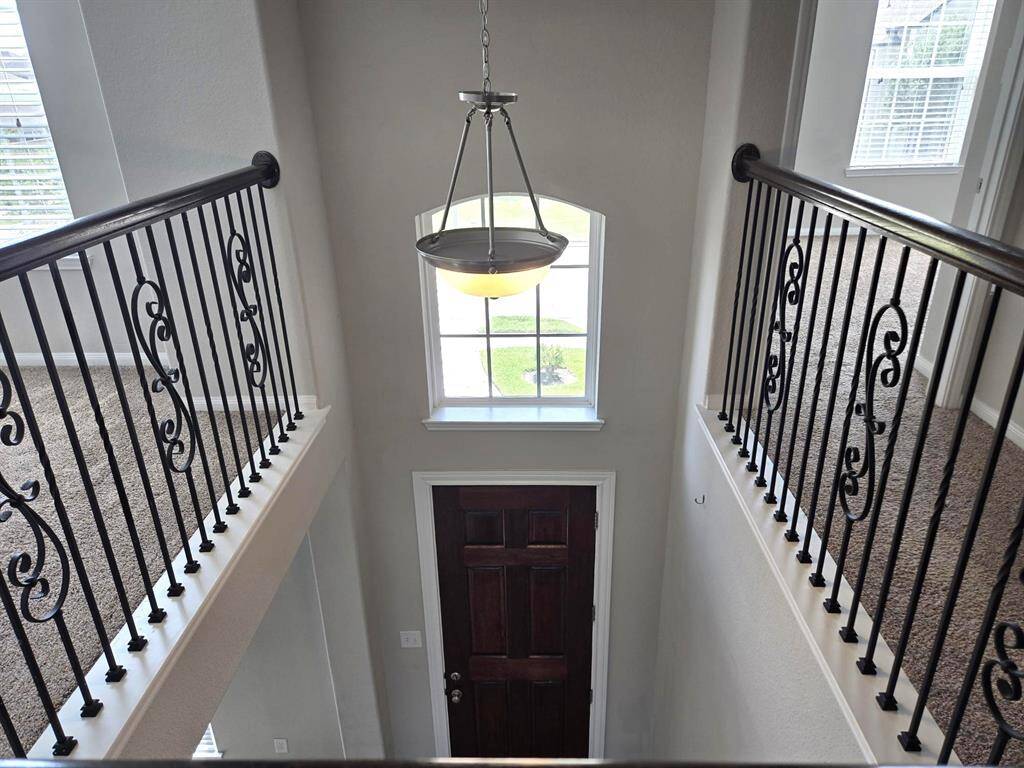Impressive and elegant two story entrance. This view is from the catwalk. Notice the stylish wrought iron spindles!
