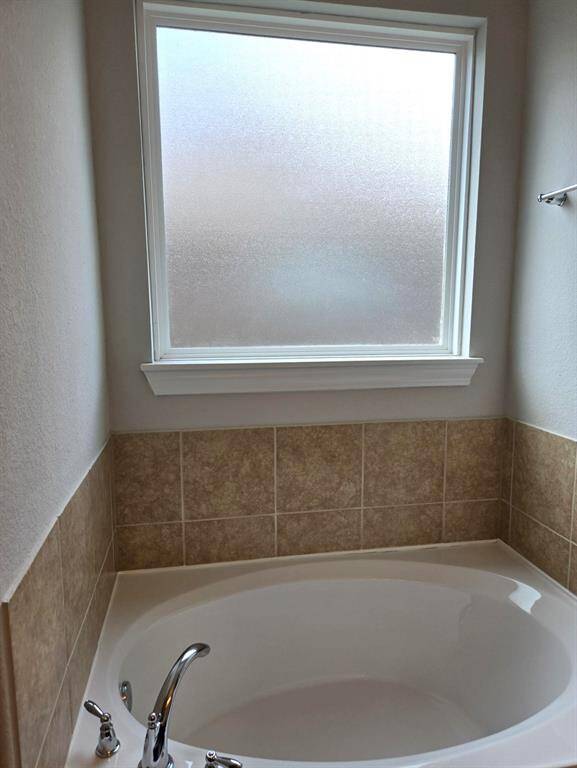 Great soaking tub. Window with frosted glass.