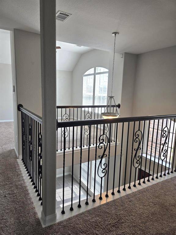 A partial view of catwalk on left and game room.  This home has beautiful architectural features!