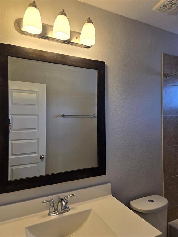 Hallway bath upstairs with framed mirror and pretty fixtues.