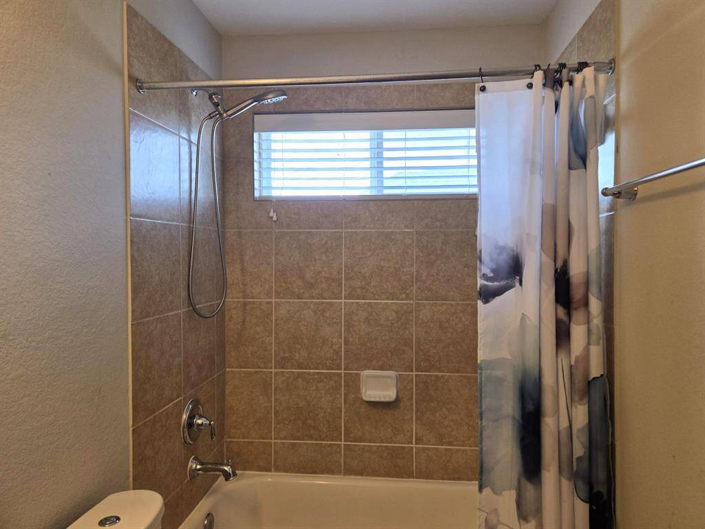 There is a tub in the hallway bathroom upstairs. Great window for natural lighting.