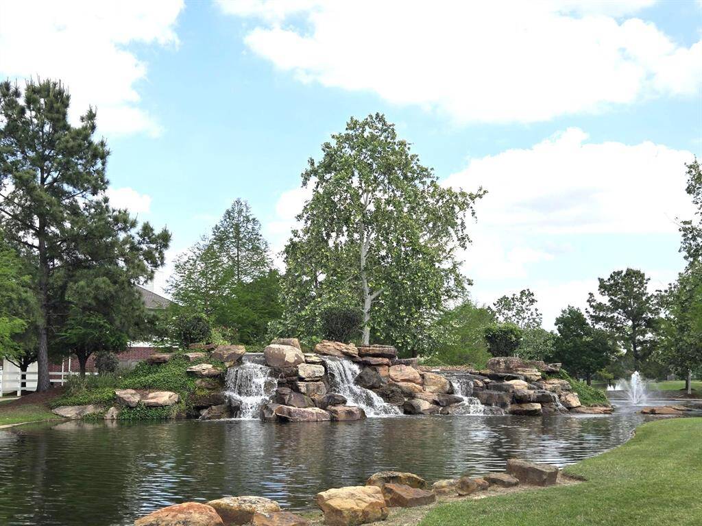 Picture perfect! This awesome view of the subdivision lake and waterfalls will greet your and your guests when entering or leaving the subdivision.