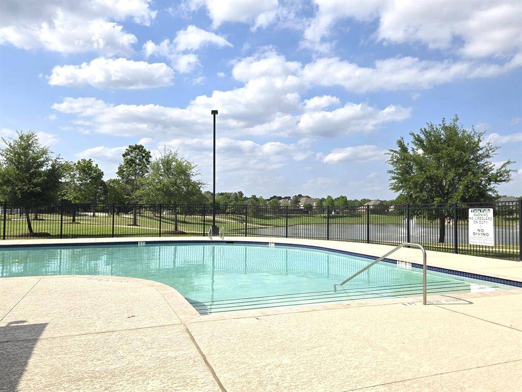 Sparkling subdivision pool and view of the lake and fountains.