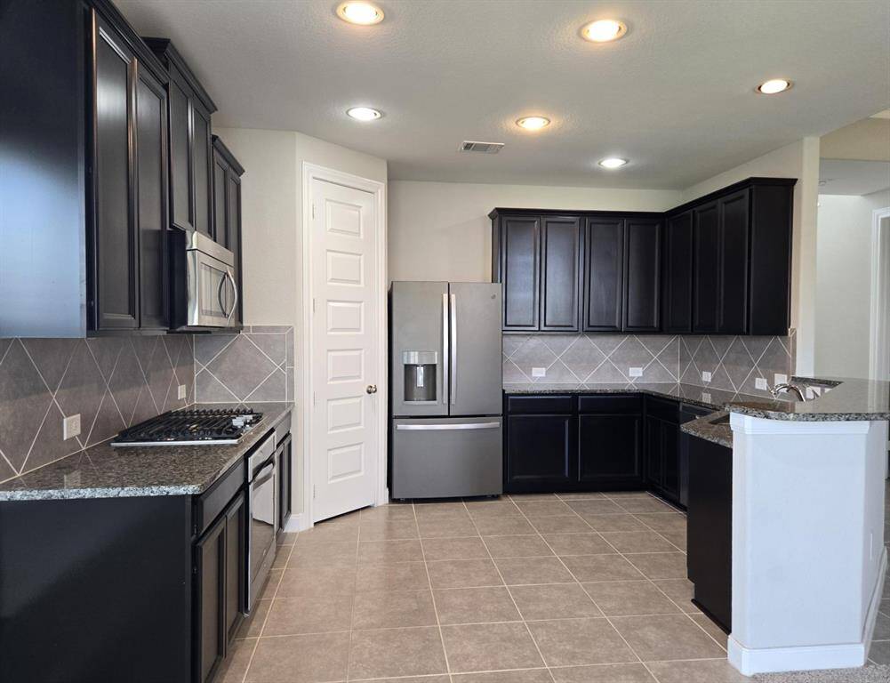 Great color palette! Rich color cabinets and pretty backsplash combination. Walk in pantry. Stainless steel appliances.