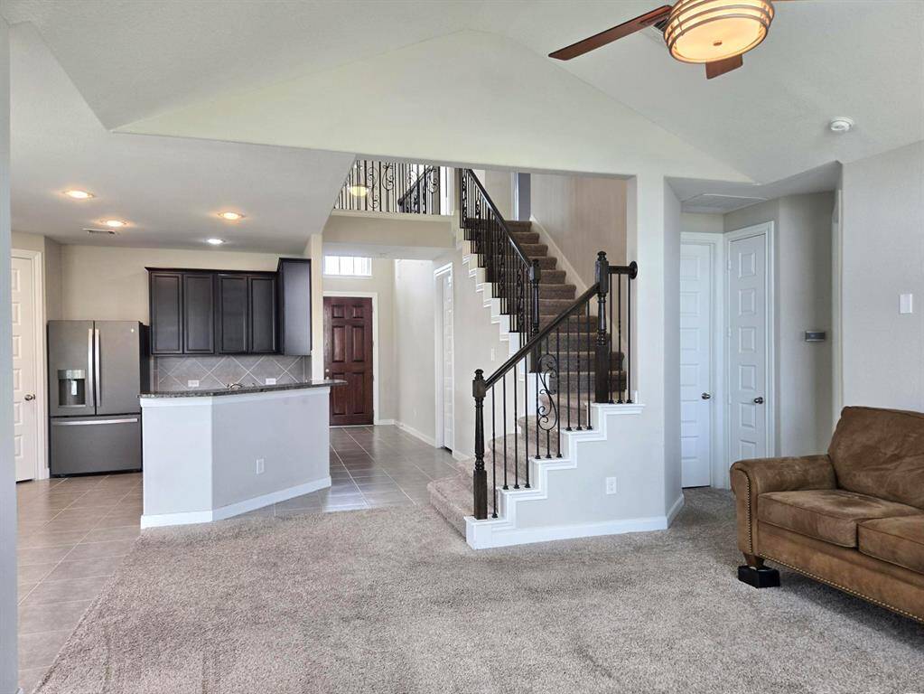 Convenient breakfast bar. View from living room to front entrance and elegant staircase.
