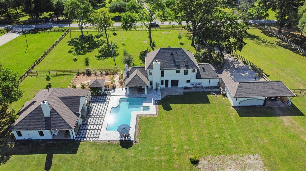 Welcome home to your gated 5 acre estate which includes a pool, hot tub, guest house, stocked pond, firepit, 4 stall barn, orchard, zipline playscape and irrigated garden.