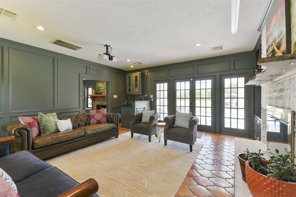 wall to wall, floor to ceiling windows and doors allow access to and from the pool patio and Guest House.