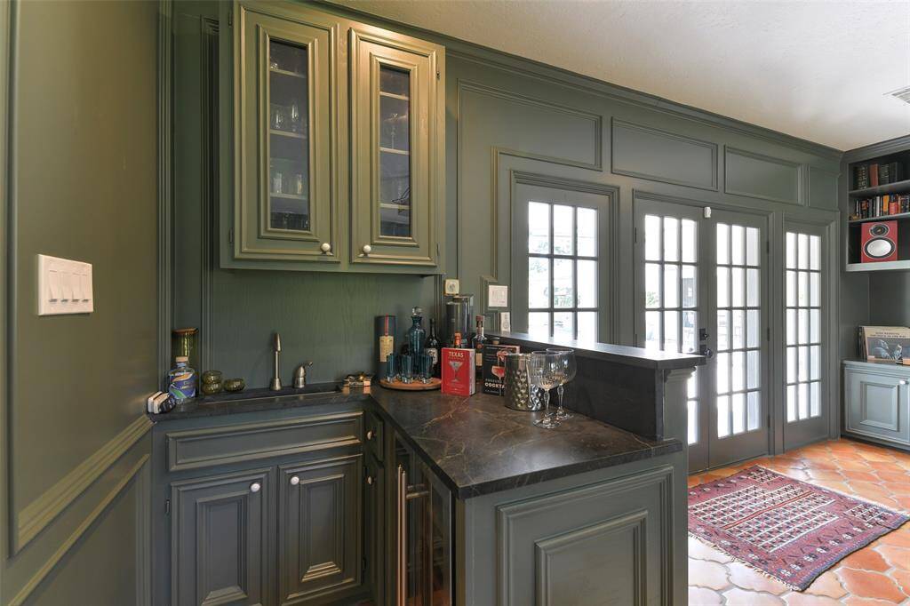 Located in the Living Room/Media Room, take a look at this wonderful Wet bar with Soapstone counter, sink and beverage refrigerator with glass cabinet doors.