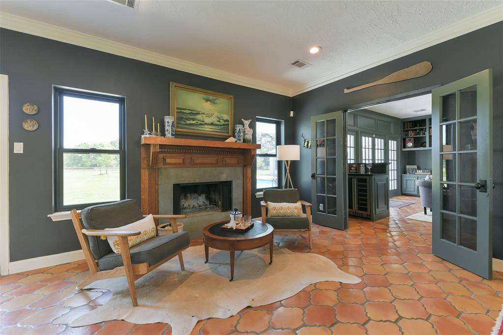 Sitting area with fireplace situated between dining room, living room and kitchen is the perfect spot for reading or lounging.  Note the sandblasted bluestone fireplace surround and solid wood mantel--perfection!