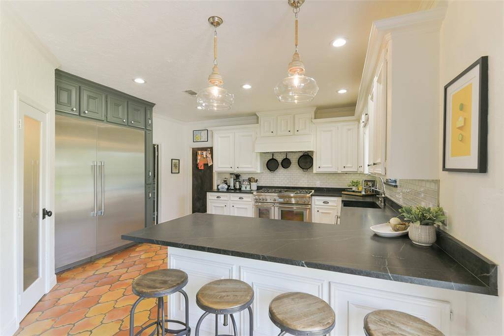 Amazing Chef's kitchen with custom Soapstone counters, two Mango Wood pendants and the most fabulous Thermador soft close built in refrigerator/freezer.