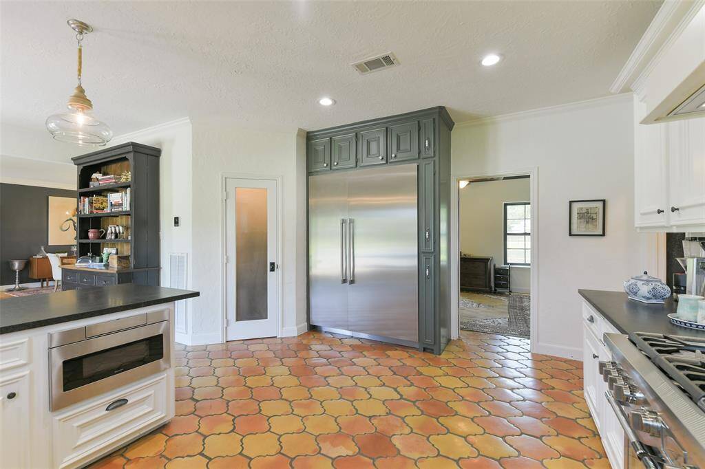 Walk in Pantry, drawer microwave and built in Thermador soft close Refrigerator/Freezer in the spacious kitchen.