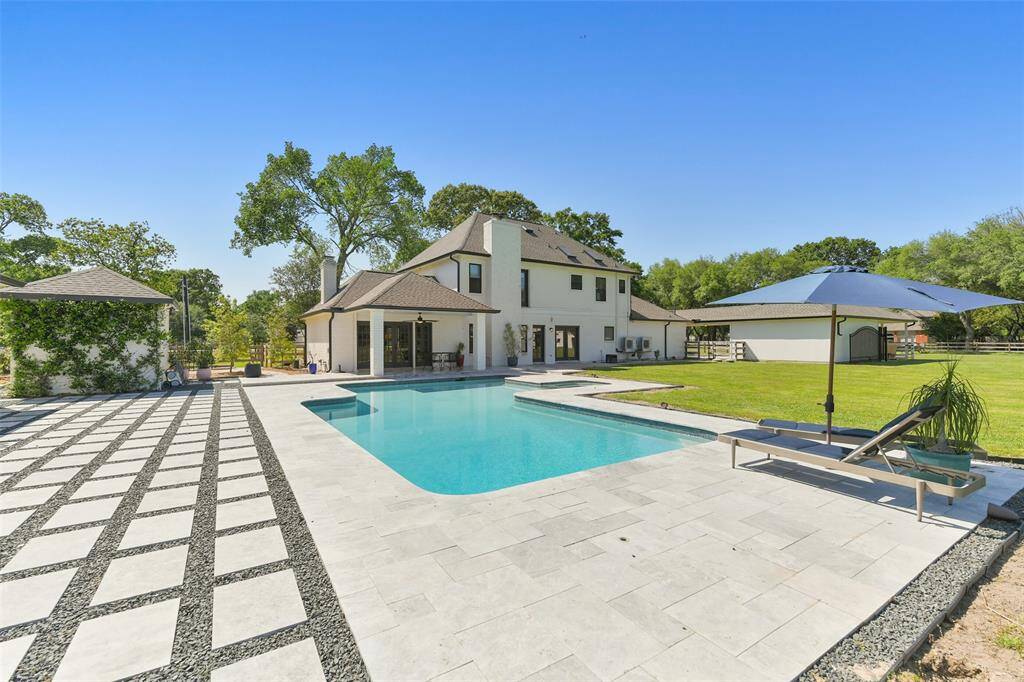 Relax by the renovated pool (2023) with guest house surrounded by manicured garden and marble deck in your very private back yard setting.