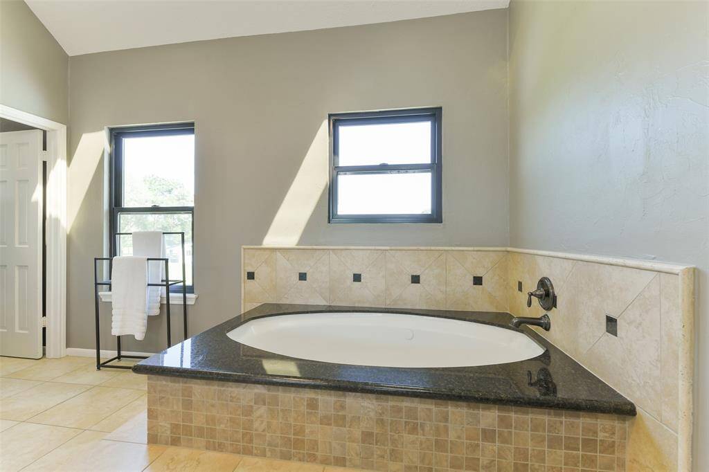 Relax in the oversized jetted tub and soak in the natural sunlight provided by the new windows and skylights.