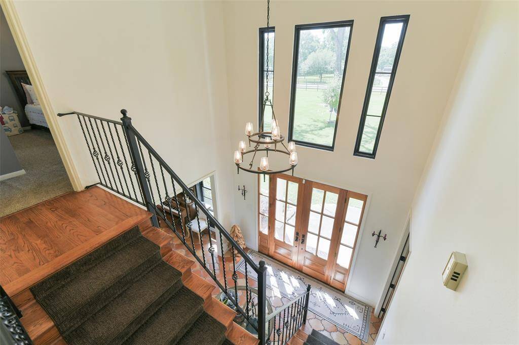Entry foyer with sky high ceiling, large windows and spectacular custom light fixture.