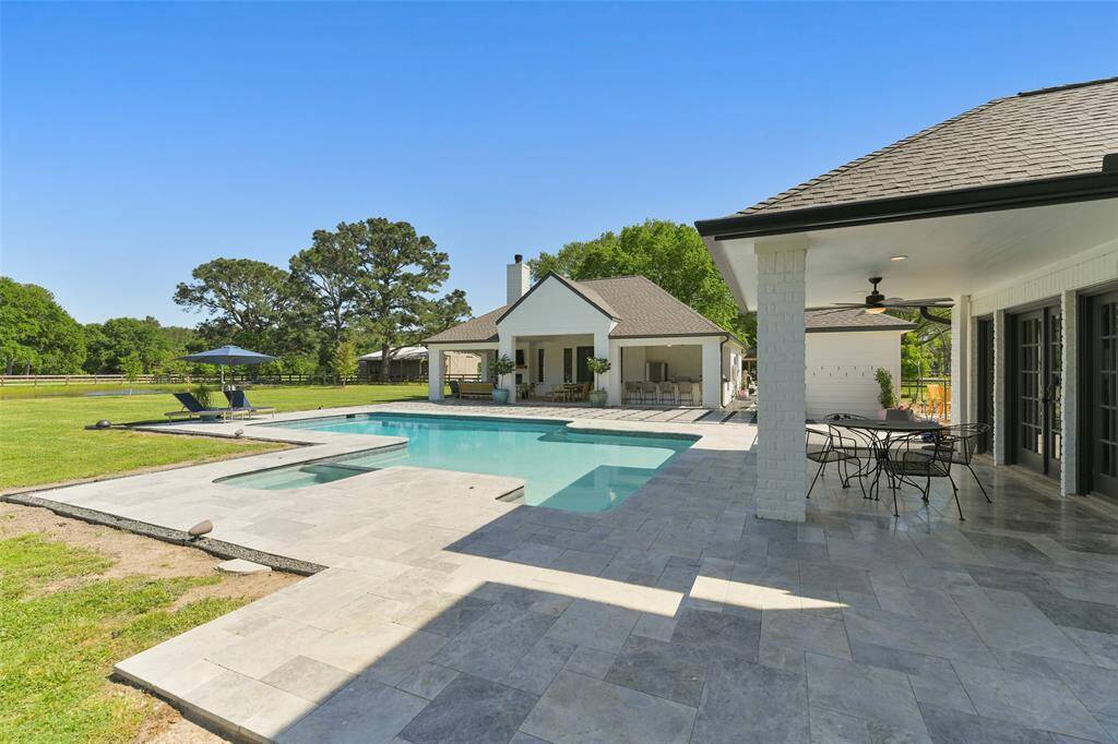 Large Pool is 11 feet deep at the deepest end and is surrounded by marble title.  Decking has umbrella holes strategically placed and has a removable pool safety cover.