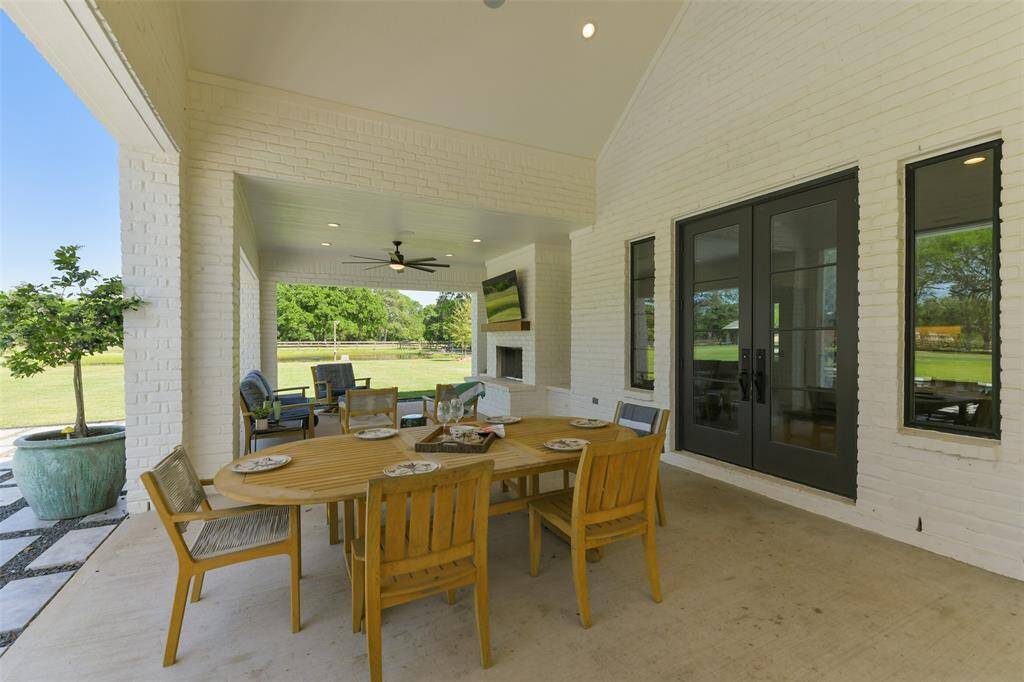 Entire outdoor entertainment area including this Dining Area is wired with SONOS music system and speakers to carry music throughout the patio and home.  Note the magnificent double doors leading to the Guest House.