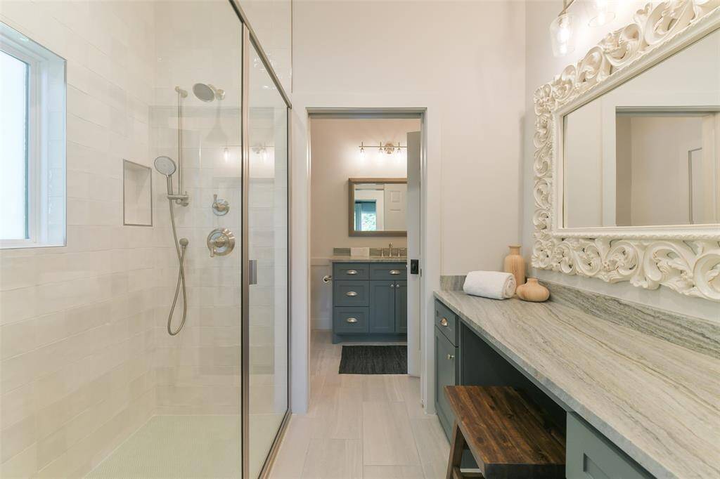 Guest House has large bathroom with step in shower and separate toilet/sink.  Plenty of counterspace and look at the beautiful mirror an light fixtures!
