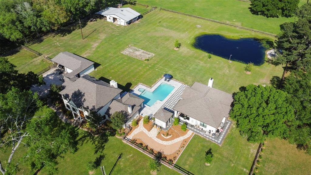 Aerial view of the main home, detached garage, carport, walking garden, pool, guest house, pond, firepit and barn all located within the first cross fence of the 5 acres.  Not shown in the back portion of the property is the playscape with the zipline and the fenced in orchard with fruit trees.