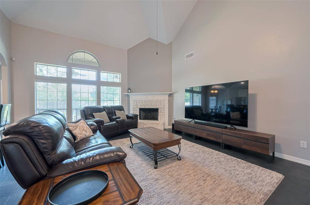 Large family room for entertaining. The wall of windows fills the space with natural light and has a great view of the backyard.