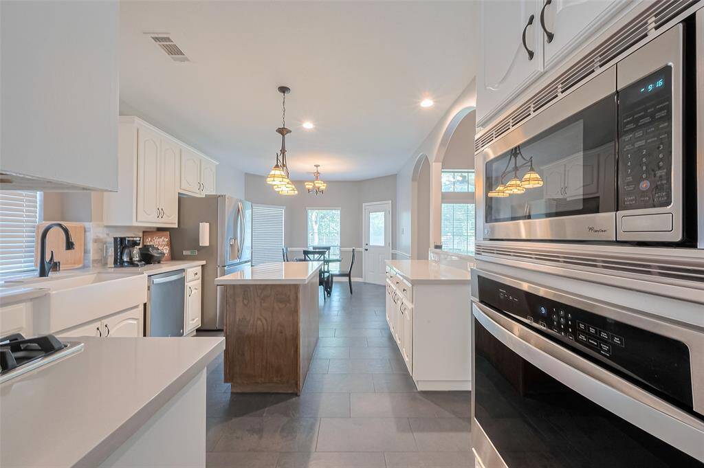 Kitchen is equipped with stainless steel appliances.