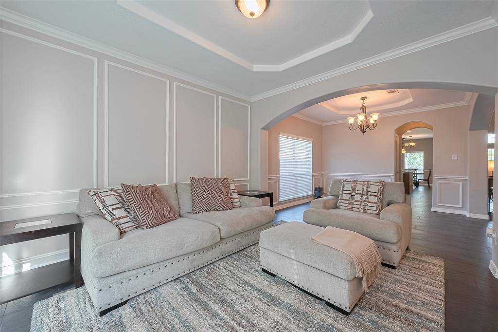 Formal living room is a cozy space to curl up and read a book.