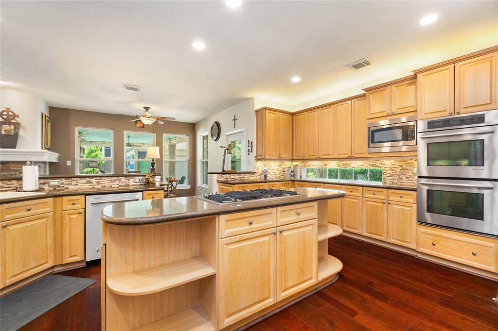 A kitchen that truly works for you. Lined with an impressive amount of cabinetry, this space offers abundant storage without sacrificing style. Just steps away, a charming breakfast nook sits bathed in natural light—perfect for morning coffee or casual meals with a view.