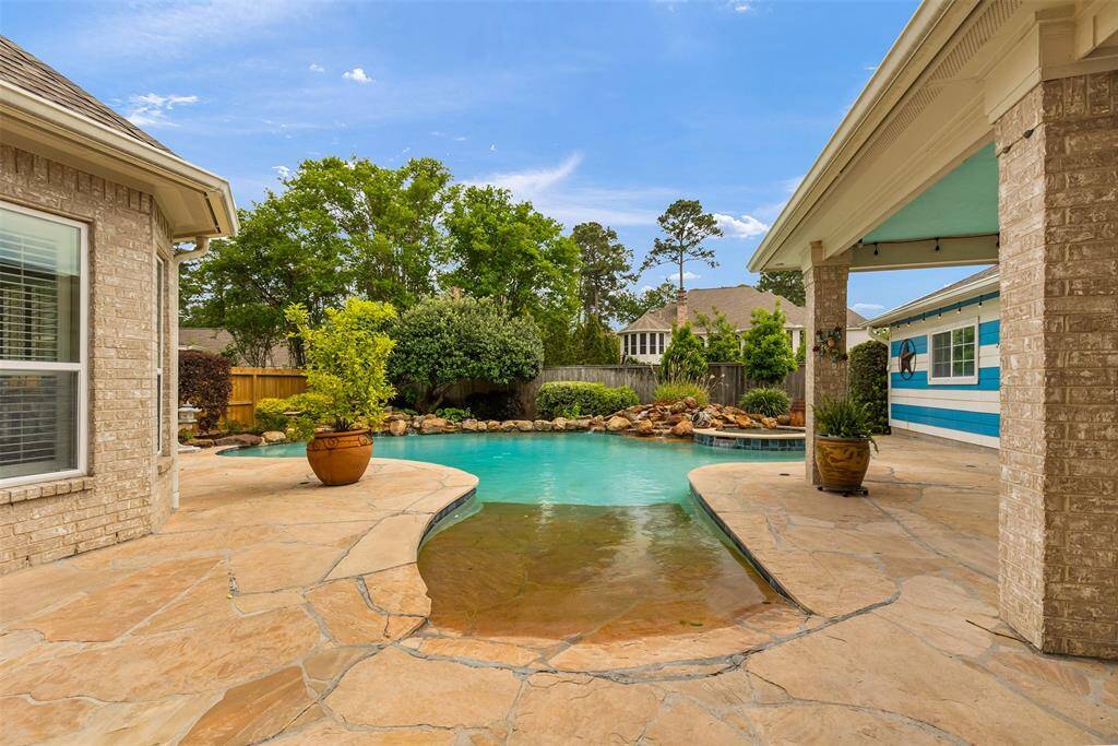 Resort-style relaxation in your own backyard. This stunning outdoor retreat features a sparkling pool with a rare walk-in beach entry—perfect for lounging in the water, watching little ones play, or enjoying a gradual, refreshing dip on warm days.