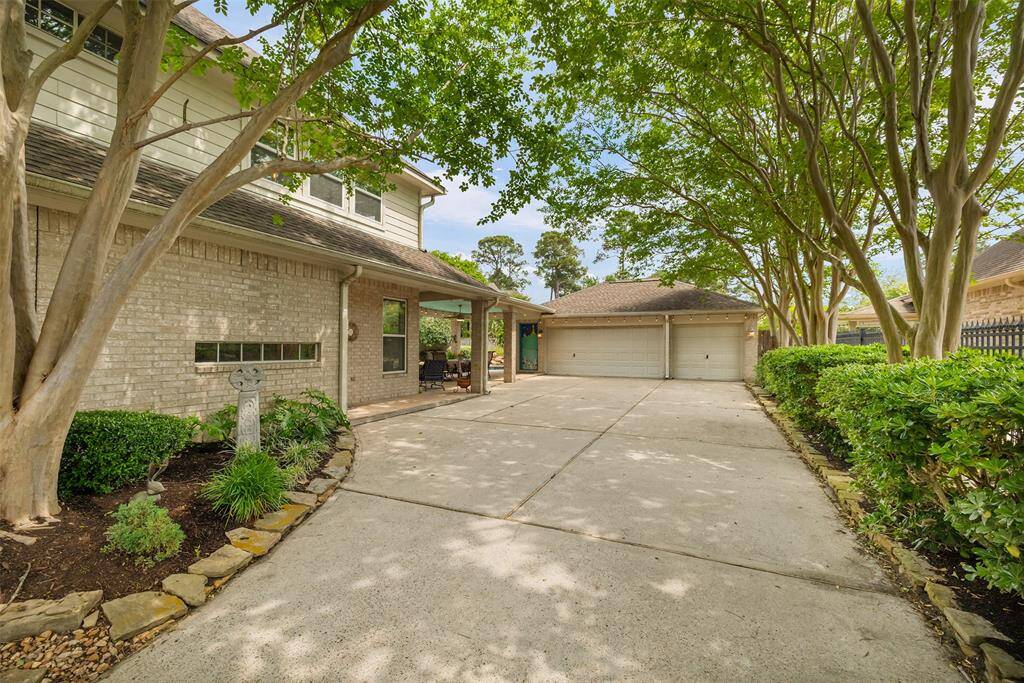 This extended driveway offers plenty of space for guest parking and leads to a spacious two-car garage. Framed by mature trees and beautifully maintained landscaping, the entrance sets a peaceful tone the moment you arrive home.