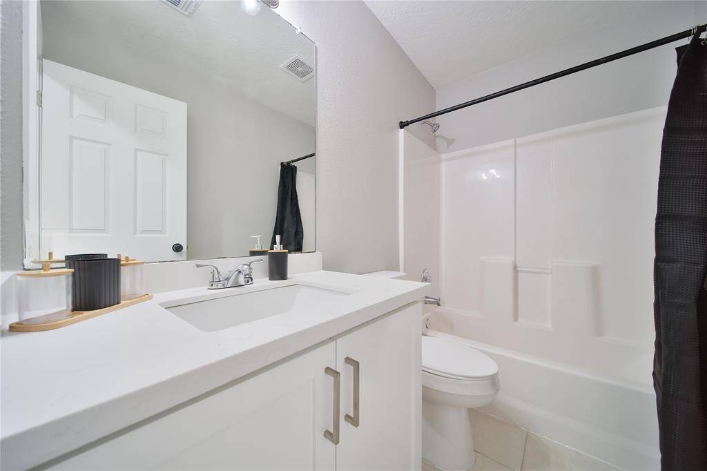 Secondary full bathroom with new countertops, cabinets and toilets