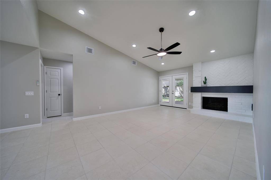 The beautiful fireplace is the center of the family room with doors leading to the outside patio.