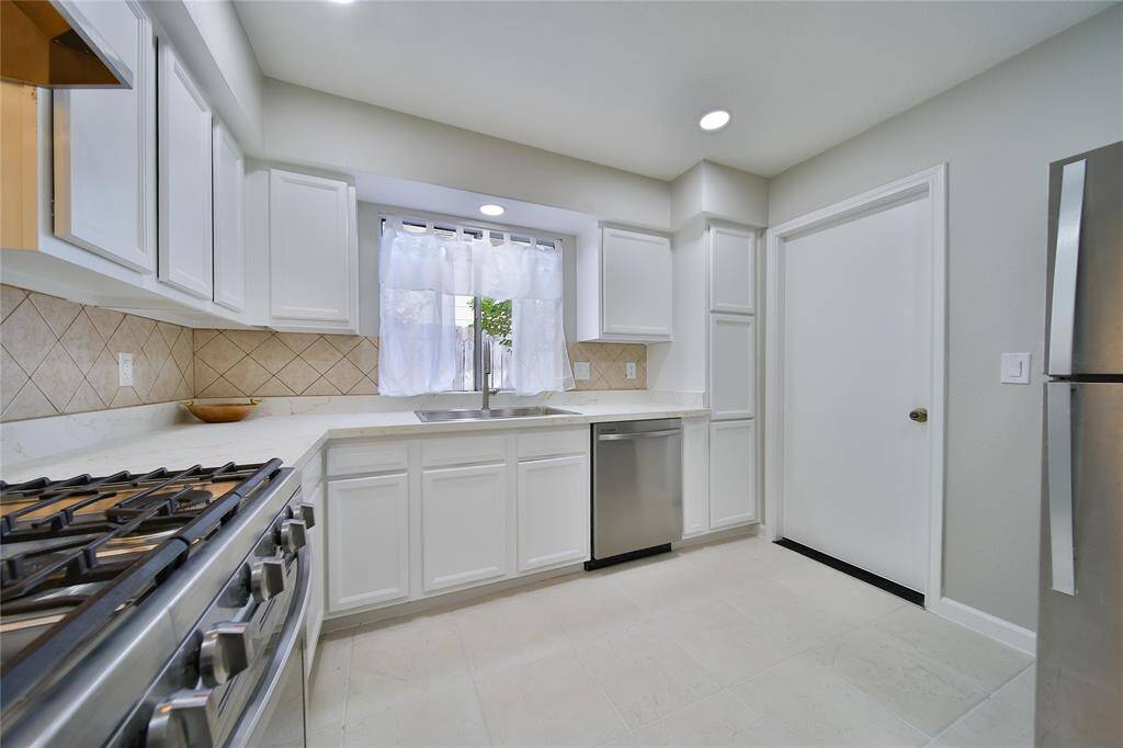Freshly painted cabinets, new granite countertops and stainless-steel appliances