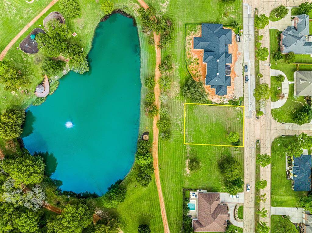 Aerial view of the lot and beautiful pond.
