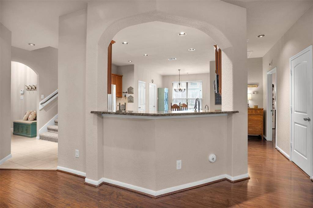 This inviting breakfast bar offers a perfect spot for casual dining and entertaining, enhancing the open-concept flow of the home.