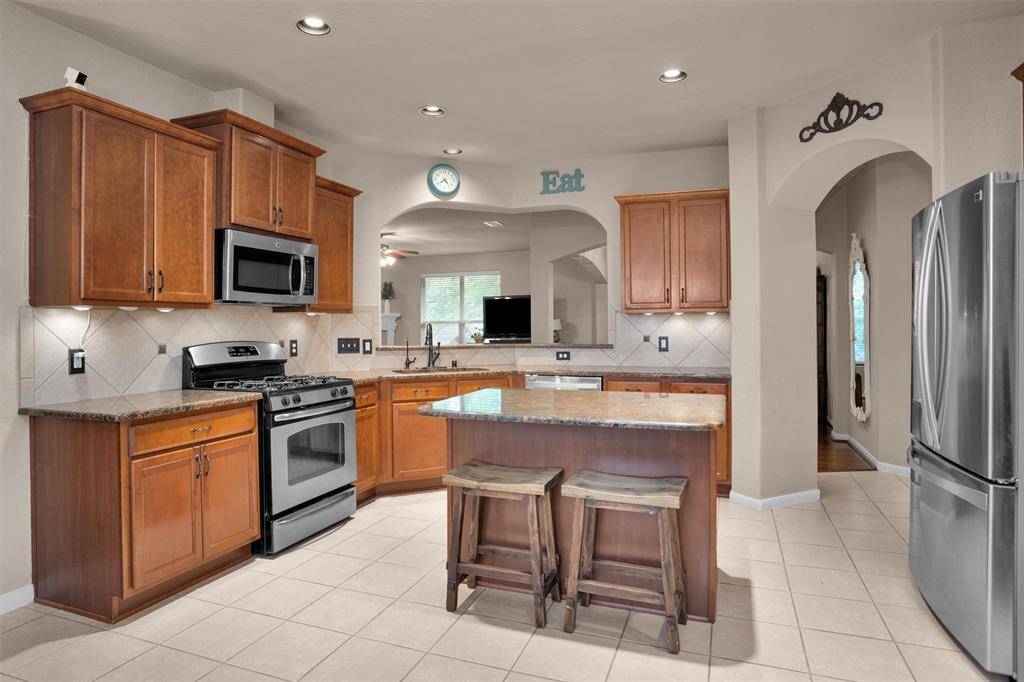 Cozy eat-in kitchen with modern appliances and ample seating space.
