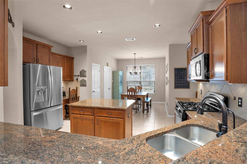 Stunning granite countertops enhance this kitchen's elegance and functionality.