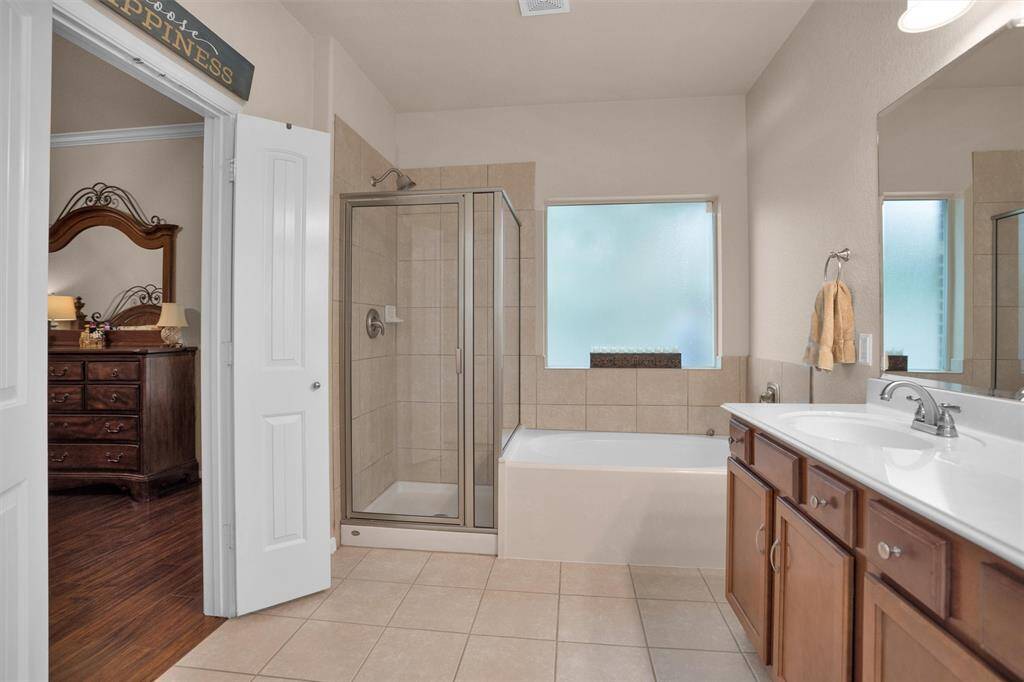This bathroom features a sleek walk-in shower for added convenience.