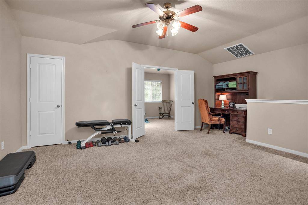 Spacious upstairs game room perfect for entertainment and relaxation.