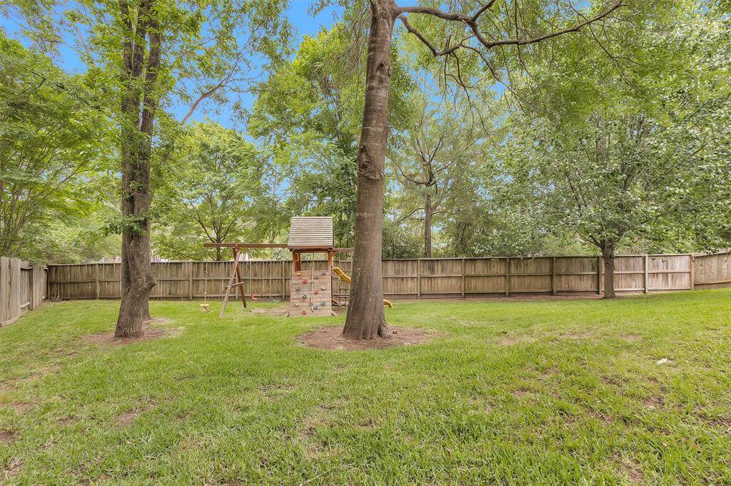 Expansive backyard with inviting covered patio.