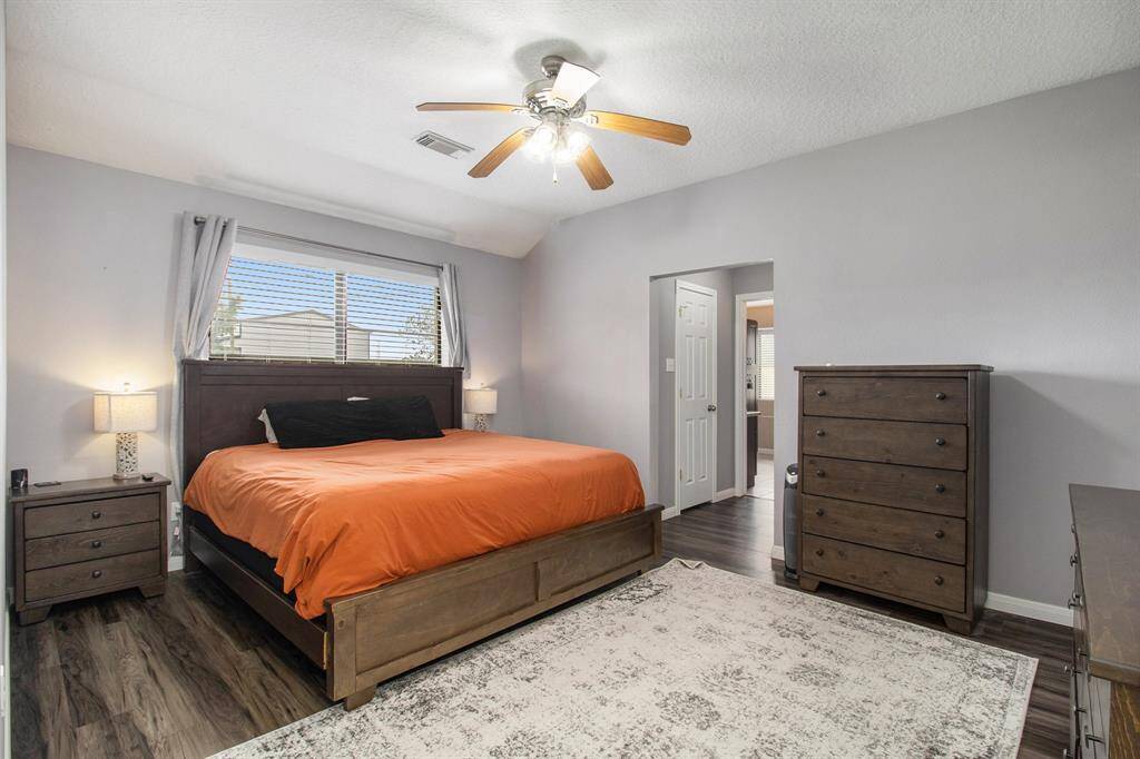 Master bedroom is very spacious and located on the other side of the home from the 2nd and 3rd bedrooms, offering privacy. It features a hallway to the master bathroom with access to his and hers walk-in closets.